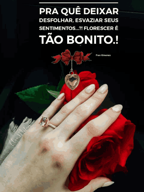 a woman 's hand holding a red rose with a ring on it