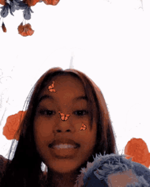 a woman with butterflies on her face is smiling