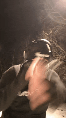 a man wearing headphones and a sweatshirt that says ' levis ' on it