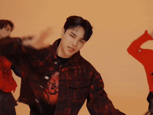 a man wearing a black shirt with a red dragon on it is dancing