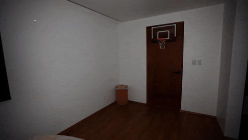 an empty room with a basketball hoop hanging on the door