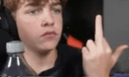 a young boy is giving the middle finger while wearing headphones and holding a water bottle .