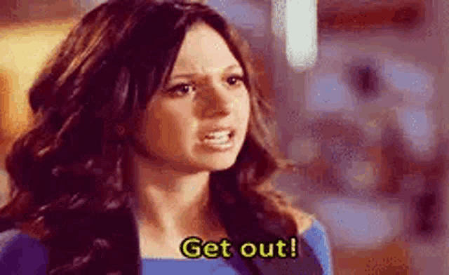 a woman is making a funny face and says `` get out '' .