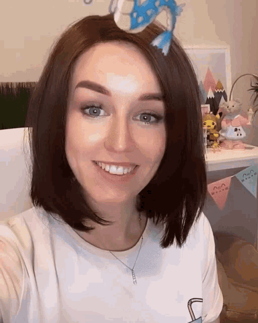 a woman taking a selfie with a toy on her head
