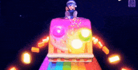 a cartoon character is sitting on top of a rainbow colored object
