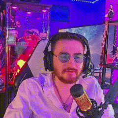 a man wearing headphones and sunglasses is sitting in front of a microphone in a room .