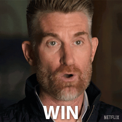 a man with a beard is making a surprised face and the word win is on his chest