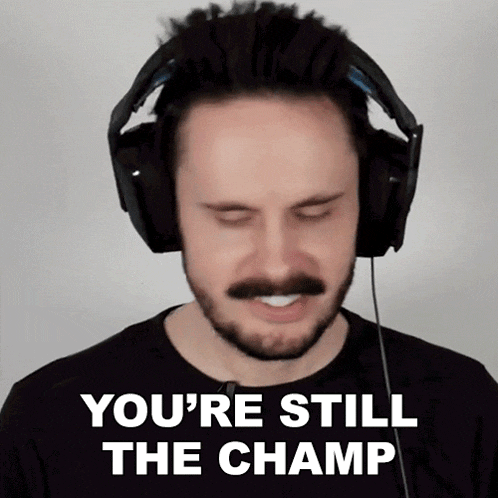 a man with a beard and mustache wearing headphones says you 're still the champ