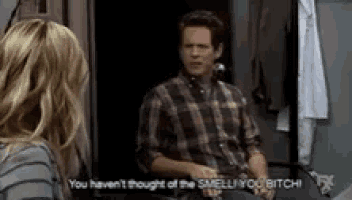 a man in a plaid shirt is sitting next to a woman in a striped shirt .