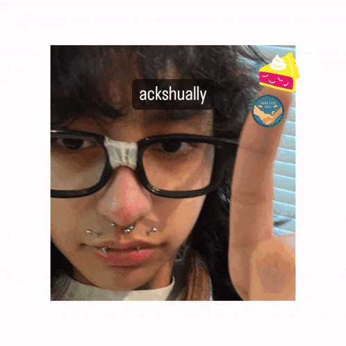 a person with glasses and a sticker that says ackshually