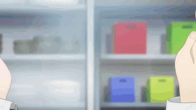 a person is holding a cup in front of a shelf with boxes on it
