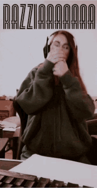a woman wearing headphones is covering her mouth with her hands and the words razziaaaaa are visible in the background