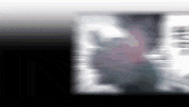 a blurry picture of a person 's face with the letter l visible .