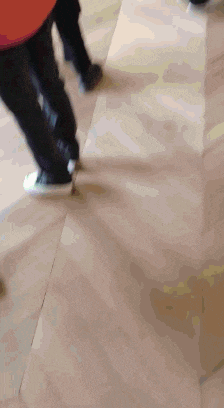 a person 's feet are shown in a blurry photo on a tiled floor