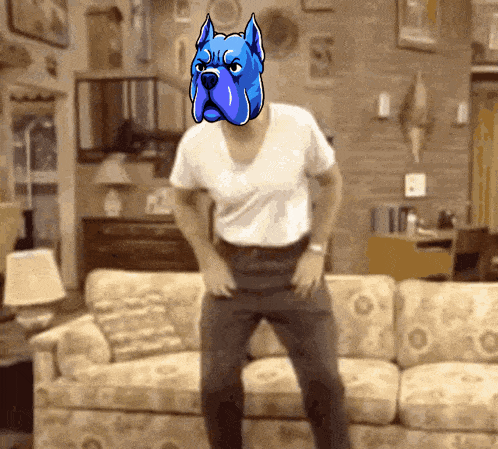 a man in a white shirt with a blue dog on his head dancing in front of a couch