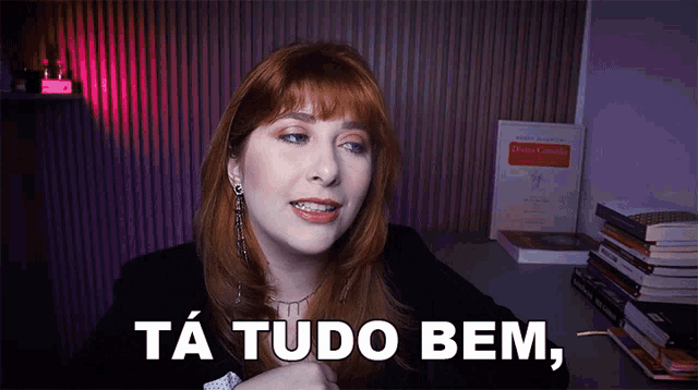 a woman with red hair says ta tudo bem in a video