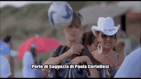 a woman in a white cowboy hat is holding a soccer ball on her head ..