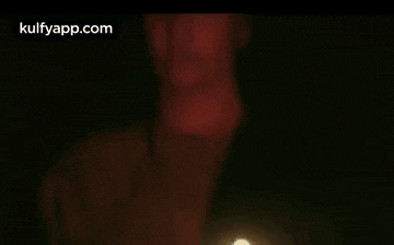a close up of a woman 's face in a dark room with her eyes closed .