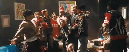a group of people are standing in a room and one of them has the number 032 on his shirt