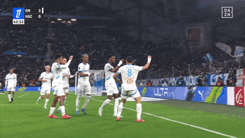 a group of soccer players are on a field with a scoreboard that says 4:33