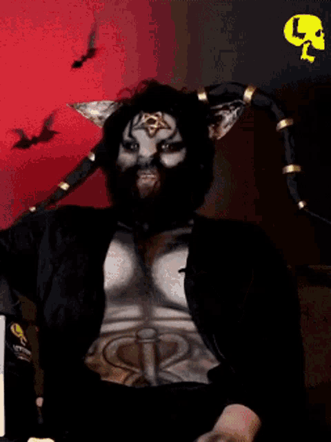 a man with horns is giving a thumbs up