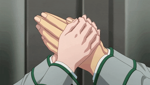 a close up of a person 's hands with a green ribbon around them