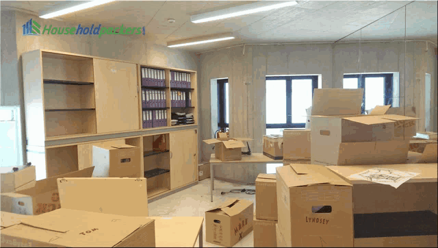 a stack of cardboard boxes in a room that says household packers on the bottom