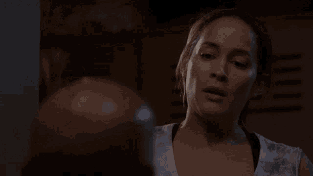 a woman holds her fist up in the air while looking at something