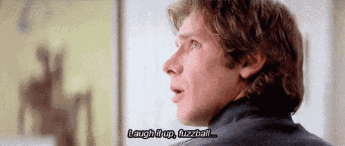 a close up of a man 's face with a caption that says laugh it up fuzzball