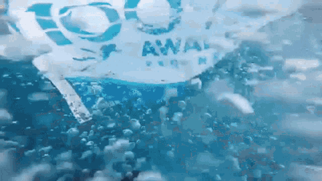 a bottle of awaii water is floating in the water
