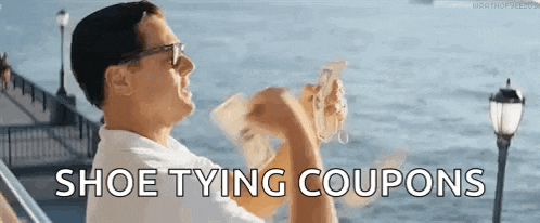 a man is sitting on a boat holding a bunch of money and the words `` shoe tying coupons '' .
