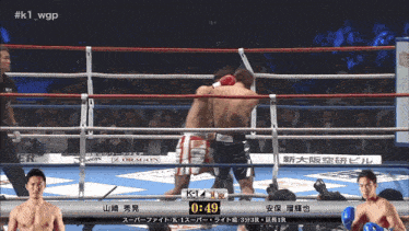 two men in a boxing ring with the time of 0:49 on the screen