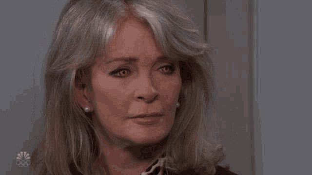 a close up of a woman 's face with the word bitch above her