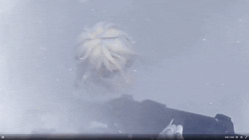 a woman with blonde hair is holding a gun in the fog
