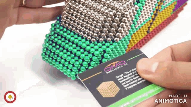 a person holding a card that says made in animotica on it