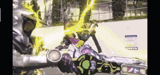 a person is riding a motorcycle with a yellow light coming out of their hand .