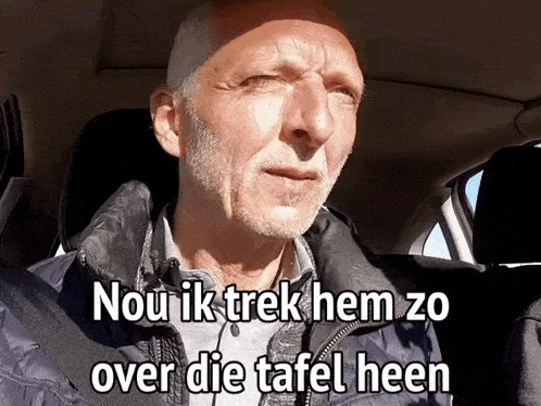 a man with a beard is sitting in a car with the words nou ik trek hem zo over die tafel heen