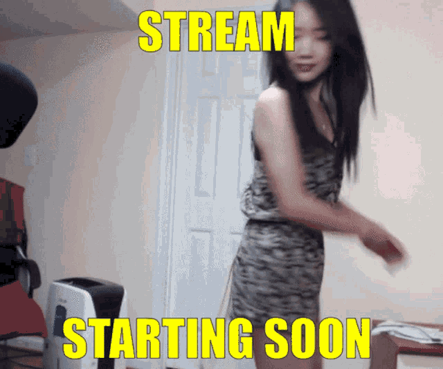 a woman in a dress is standing in front of a sign that reads stream starting soon
