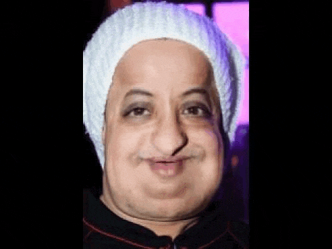 a close up of a man wearing a white hat making a funny face .