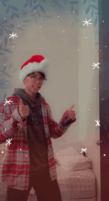 a young man wearing a santa hat and a plaid shirt that says the north face