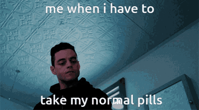 a man stands in front of a ceiling and says me when i have to take my normal pills