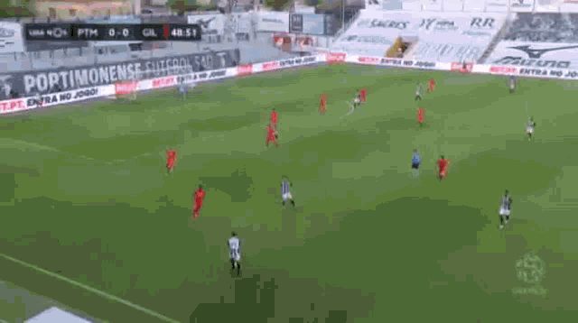 a soccer game is being played in a stadium and the score is 1-0