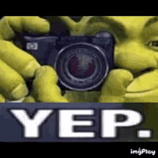 shrek is holding a camera in front of his face and says yep on the bottom .