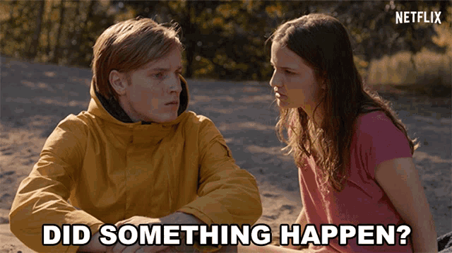 a man and a woman are sitting in the sand with the words did something happen