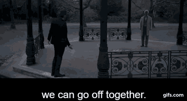 a man in a bow tie is standing in a park .