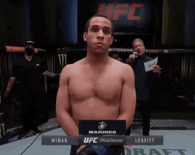 a man standing in front of a sign that says ufc official decision