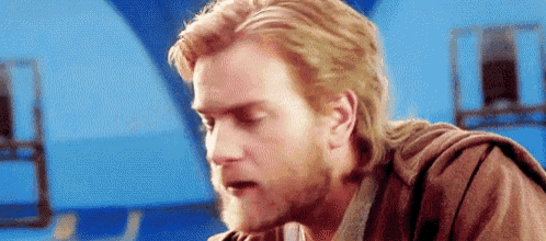 a close up of a man with a beard and long hair .