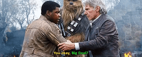 two men shaking hands with a chewbacca in the background