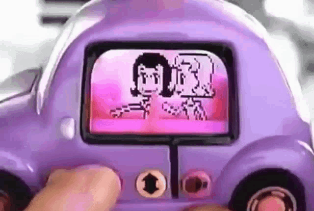 a person is holding a purple toy car with a picture of a couple on the screen .