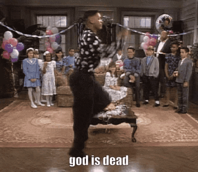 a man is dancing in front of a group of children with the words god is dead written on the floor